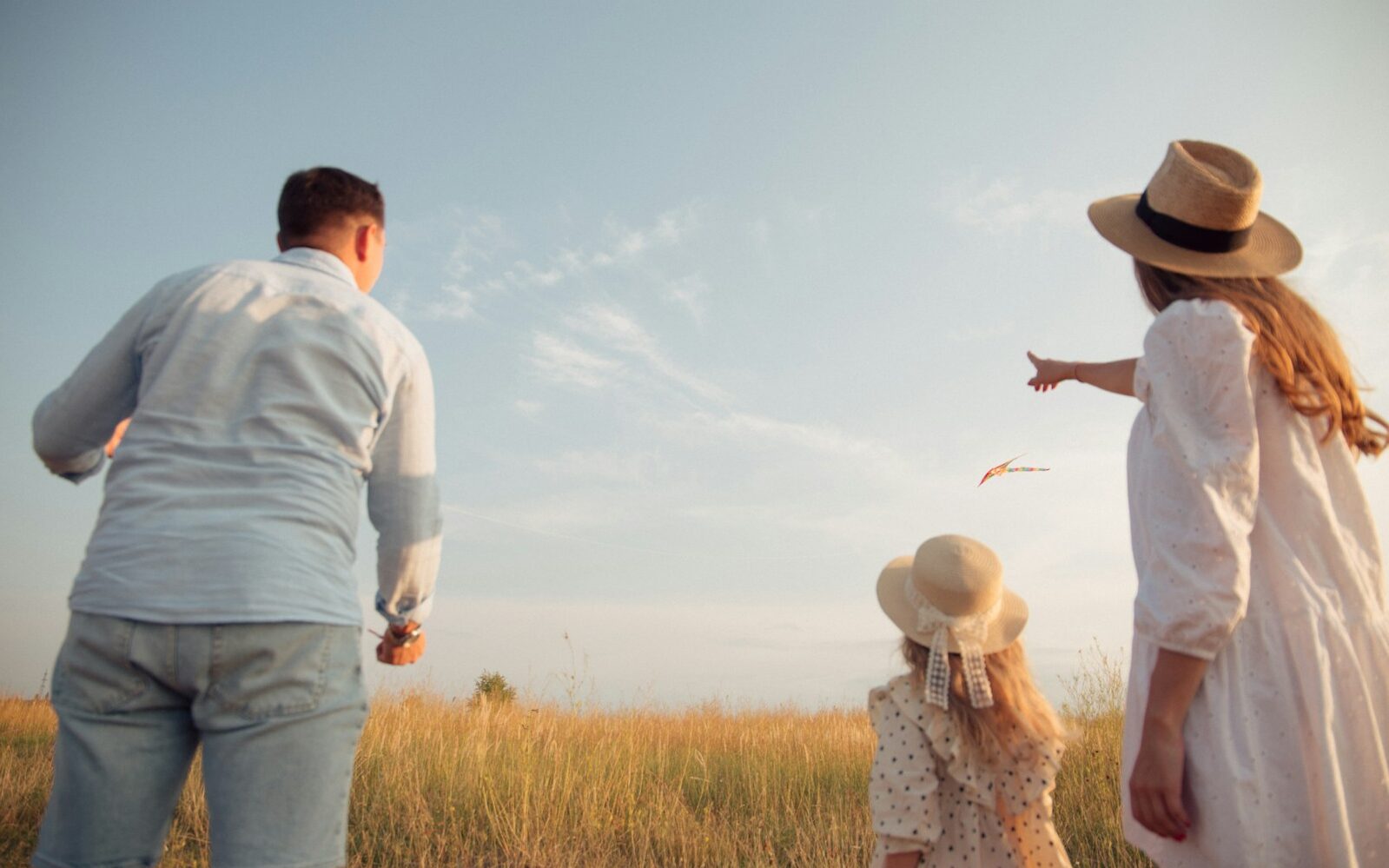 man in white dress shirt and woman in brown dress standing on green grass field during